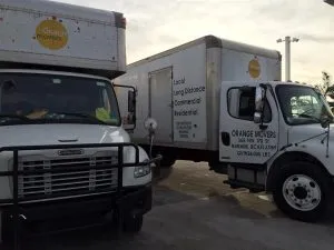 two white moving trucks - moving services Florida