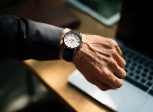 A man with a watch, being punctual.