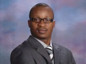 African-American man in a suit, wearing glasses