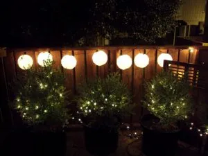 Backyard lanterns on the fence