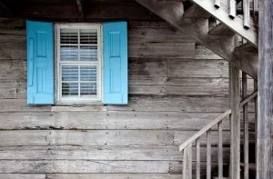 A blue window shutter to help you hurricane proof your house.