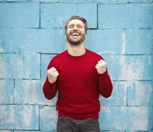 a happy man in a red sweater