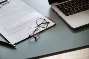 a contract next to a laptop