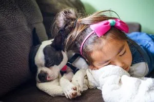 girl sleeping next to a dog - one of the best packing tips for busy mums