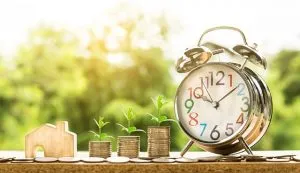 Money and alarm clock - time and money are important when moving in with your partner