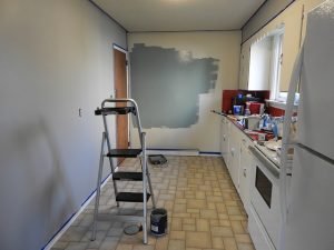 Kitchen remodeling with grey painted wall.
