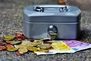 A money box with paper money and coins