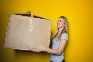 A woman holding long distance DIY relocation packing supplies