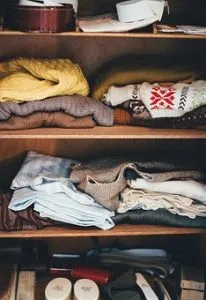 folded clothes in a cabinet