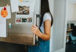 prepare appliances for relocation - a girl with a fridge