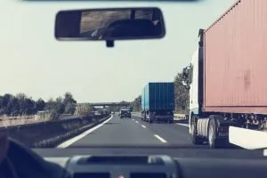 Passing by moving trucks on a highway