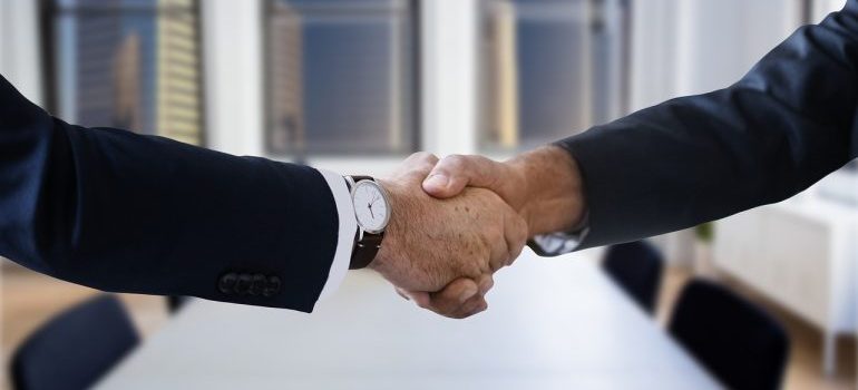 A handshake between two people. 