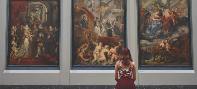 A woman looking at paintings.
