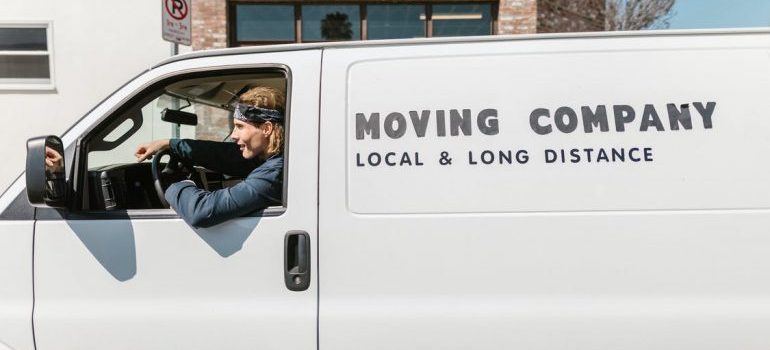 White moving van labeled local and long-distance as an example of movers Miami FL