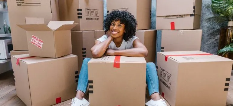a woman sitting among the boxes 