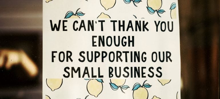 a sign with "We can't thank you enough for supporting our small business" written on it