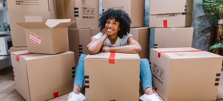 woman with boxes smiling 