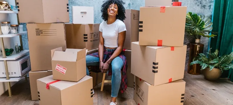woman sitting on packing boxes