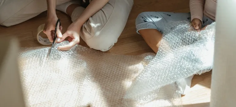 Two people using bubble wrap