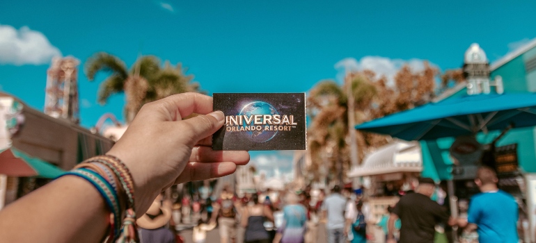 person holding Universal Studios card 