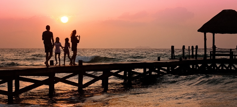 family enjoying the sunset on the beach