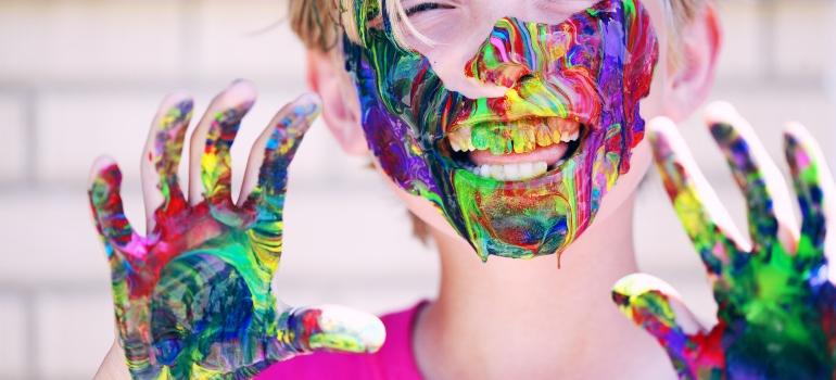 boy laughing with paint on his face