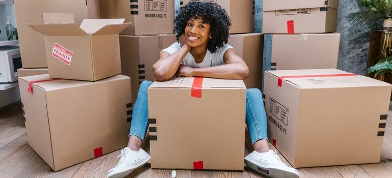 woman surrounded by boxes ready to move to one of the top places in Florida for entrepreneurs 