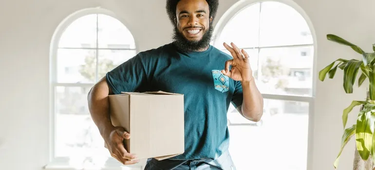 a mover holding a box 