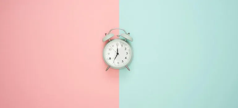 clock on a pink and mint surface