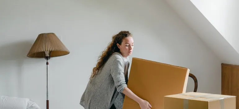 woman lifting heavy box 