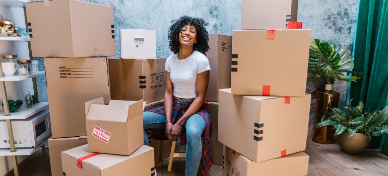 Woman surrounded with moving boxes
