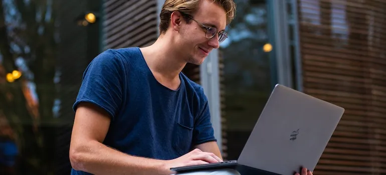 Man using a laptop to explore fun things to do in Davie as a newcomer