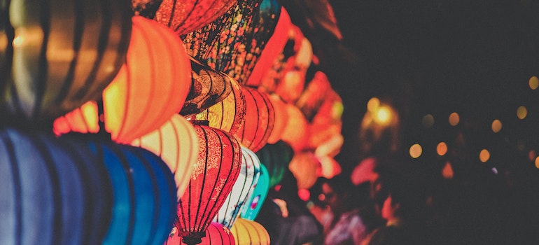 Colorful lamps illuminating a local festival with live music and cultural performances.